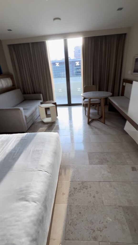 Photo of Resort View King room at Hyatt Ziva Cancun. The bed, sofa bed, table and built-in seat are visible,